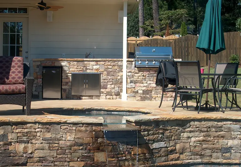 Masonry Contractor in NJ. Stone hardscaping and pool waterfall.
